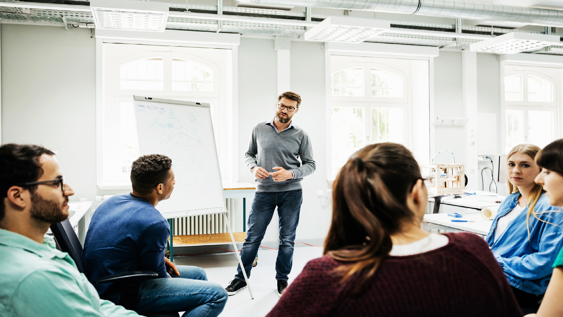 a man standing in front of a whiteboard