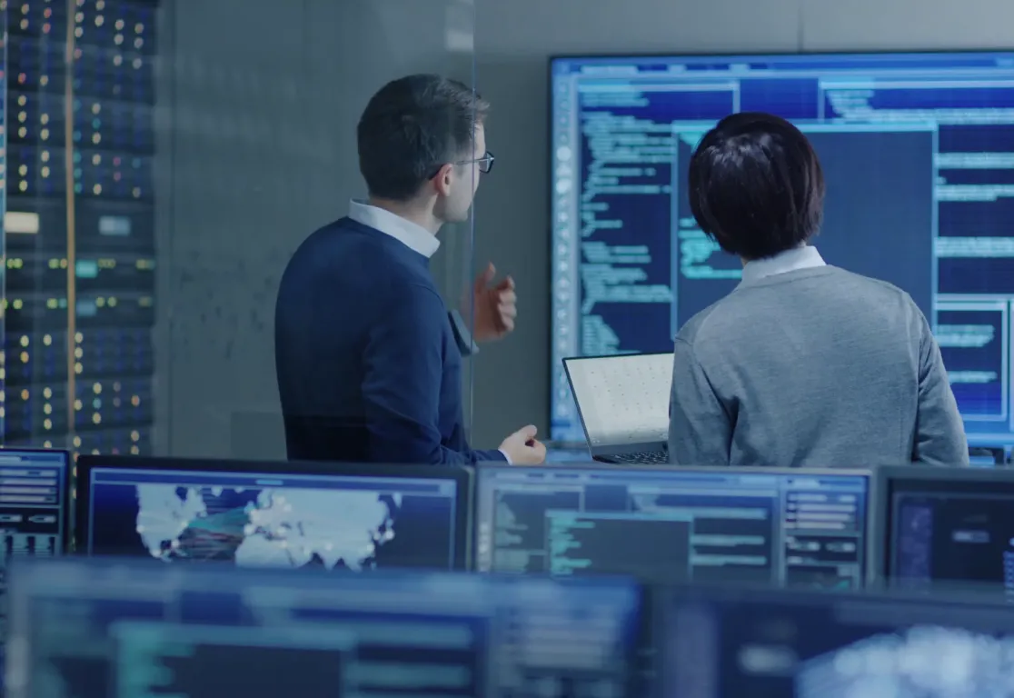 a man and woman looking at screens a man and woman looking at screens
