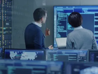 a man and woman looking at screens