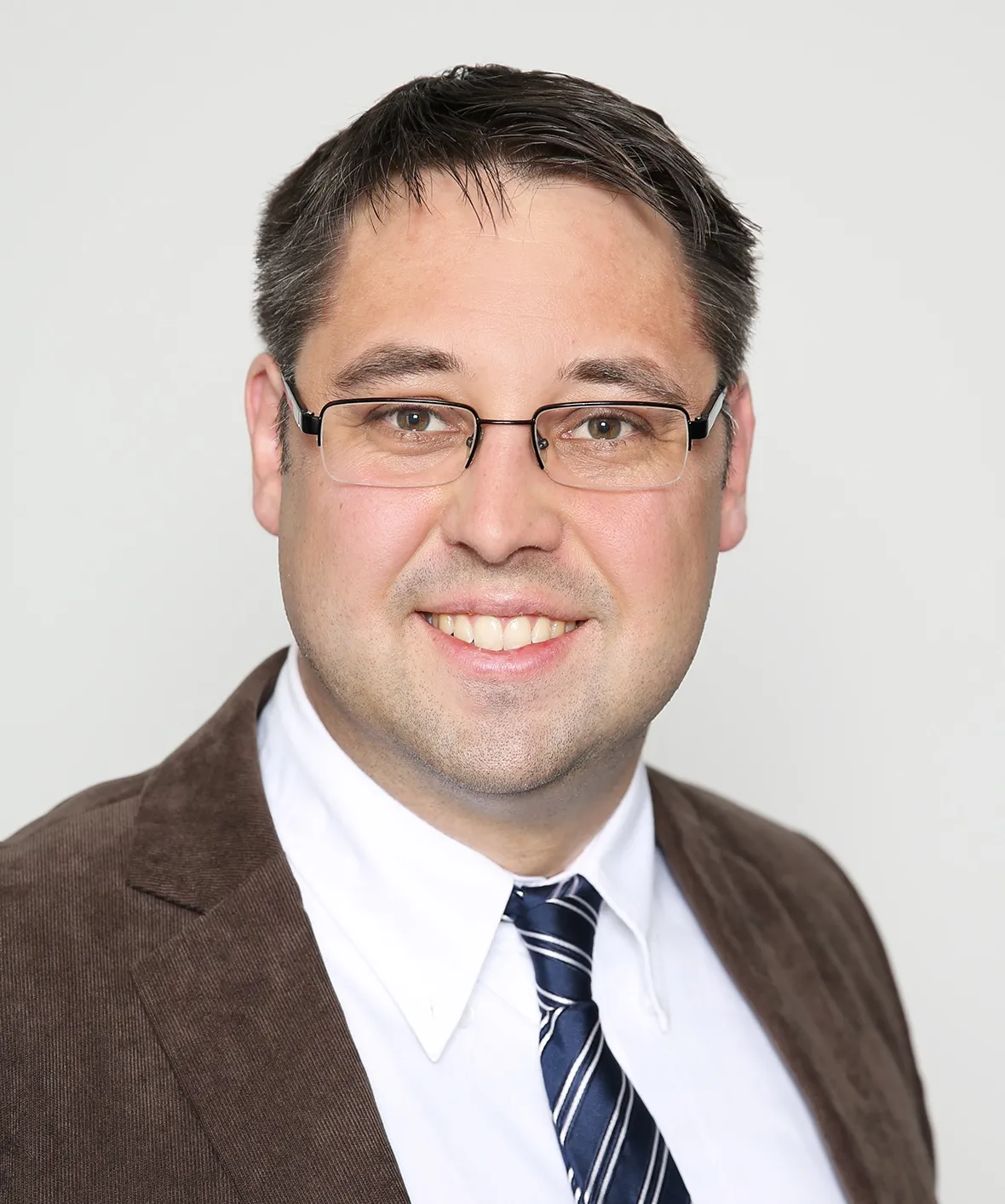 a man wearing glasses and a suit